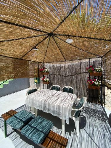 a table and chairs under a large umbrella on a patio at Bright and spacious apartment with outdoor space in Kaštela