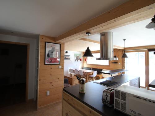 a kitchen with wooden walls and a counter top at Appartement Valloire, 3 pièces, 6 personnes - FR-1-263-466 in Valloire