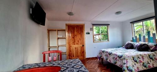 a small room with a bed and a window at Henua Roa Loft in Hanga Roa