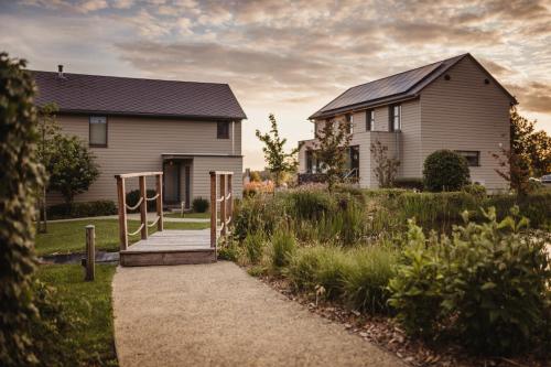 a house with a pathway in front of a house at Golden Lakes Village Ardennes in Boussu-lez-Walcourt