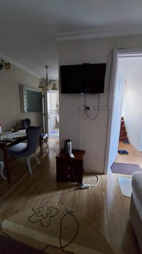a living room with a television on the wall at Boutique hotel in Poti