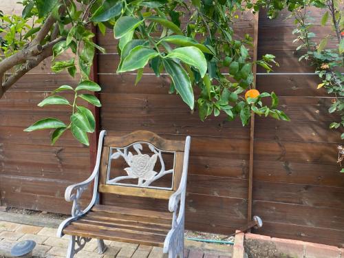 a wooden bench sitting in front of a fence at Sunside Inn Hotel in Kérynia