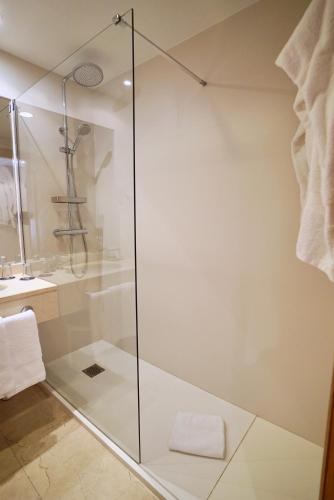 a shower with a glass door in a bathroom at Gran Hotel Victoria in Santander