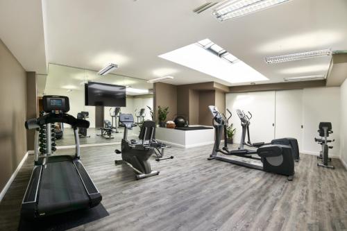 a gym with treadmills and cardio equipment in a room at Park Inn by Radisson Luxembourg City in Luxembourg