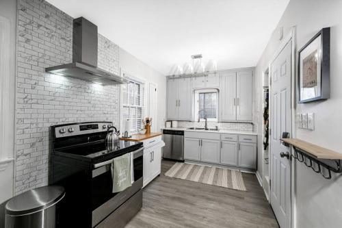 a kitchen with white cabinets and a black stove top oven at Shaker Heights- WiFi, 1st Floor in Shaker Heights