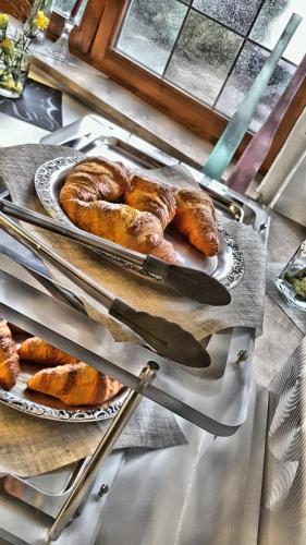 a table with two plates of pastries and bread at Hotel Hellers Twenty Four II -24h-Check-In- in Friedrichshafen
