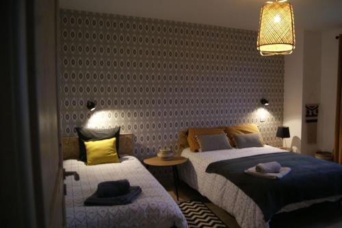 a bedroom with two beds with hats on them at VILLA BELLE D'OPALE in Wierre-Effroy