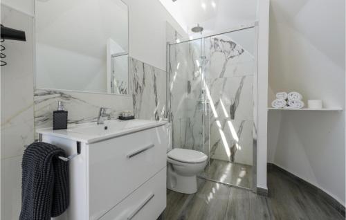 a white bathroom with a toilet and a sink at Nice Apartment In Caravaca De La Cruz With House A Mountain View in Caravaca de la Cruz