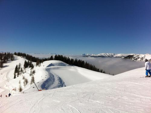 a group of people skiing down a snow covered slope at Gurkhof Ferienwohnungen in Gnesau