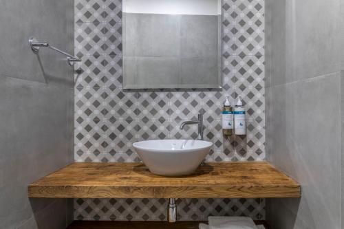 a bathroom with a sink and a mirror at Numa Florence Fiore in Florence