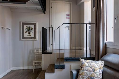 a glass case in a living room with a couch at Numa Florence Fiore in Florence