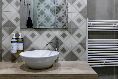 a bathroom with a white bowl sink on a counter at Numa Florence Fiore in Florence