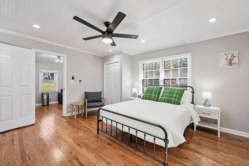 a bedroom with a bed and a ceiling fan at Private 1BR Cottage In Downtown Historic Norcross in Norcross