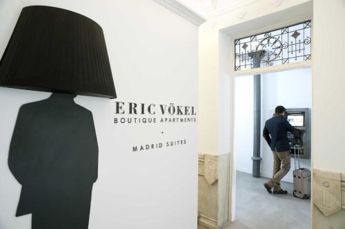 a man taking a picture of a statue in a building at Eric Vökel Boutique Apartments - Madrid Suites in Madrid