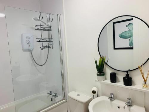 a bathroom with a shower and a sink and a mirror at Salisbury Solace in Salisbury