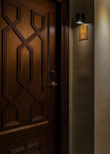 a wooden door with a sign that reads exit at Vincci Albayzin in Granada