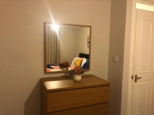a mirror on top of a dresser in a room at Cute flat in Whitechapel in London