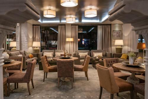 a living room with a couch and tables and chairs at Vincci Albayzin in Granada