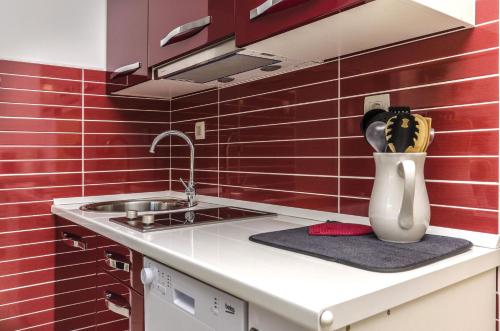 a kitchen with a sink and a vase on a counter at Apartment Mare in Srima