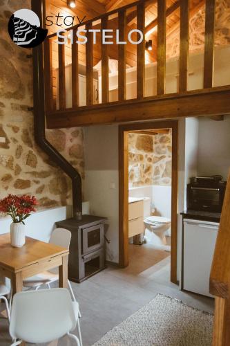 a living room with a wood stove in a house at Casa da Carreirinha in Arcos de Valdevez