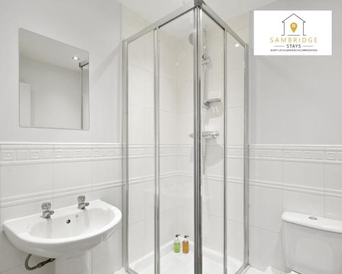 a white bathroom with a shower and a sink at Beautiful 2 Bedroom Seviced Apt in Aylesbury By Sambridge Stays Short Lets & Serviced Accommodation in Aylesbury