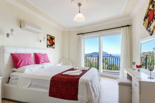 a bedroom with a bed and a large window at Villa Azalea in Kalkan