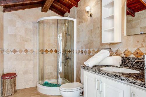 a bathroom with a shower and a toilet and a sink at Villa Azalea in Kalkan