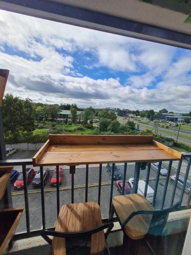 a balcony with a table and chairs and a view of a parking lot at Departamento Osorno 215 in Osorno