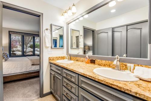 a bathroom with two sinks and a large mirror at Arrowhead Ski Condo in Edwards