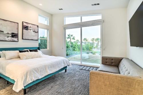 a bedroom with a bed and a couch and a window at Sleek and Modern Home with Views and Pool Access in Indian Wells