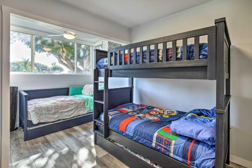 a bedroom with two bunk beds and a window at Waterfront Huntington Beach Condo with Fire Pit in Huntington Beach