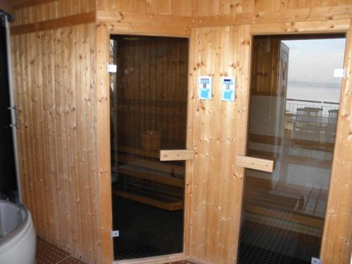 a wooden cabin with two glass doors in it at Royal Mediterran in Siófok