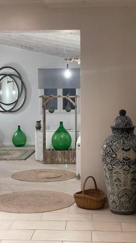 a room with vases and a basket on the floor at vraxleri house in Kassiopi
