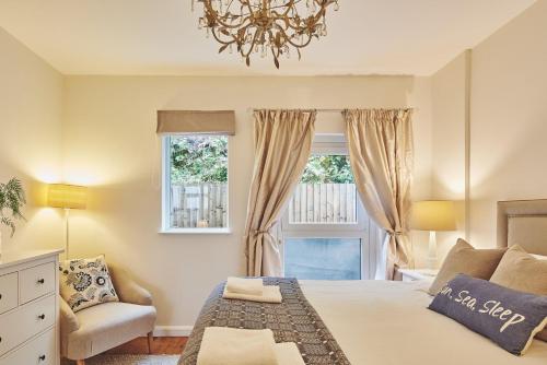 sypialnia z łóżkiem, krzesłem i oknem w obiekcie Ty Gwawr w mieście Oxwich