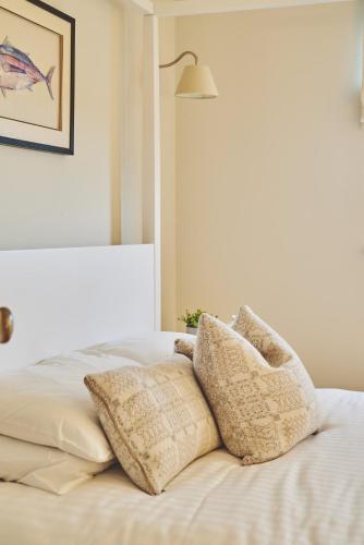 a bed with two pillows on top of it at Ty Alice in Oxwich