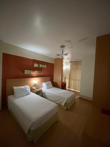Ένα ή περισσότερα κρεβάτια σε δωμάτιο στο Líber Hotel Nova Serrana - Conforto na Rota da BR-262