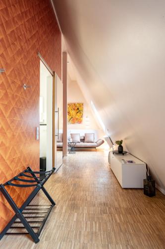 a living room with a couch and a table at Abbate Boutique Hotel in Ulm