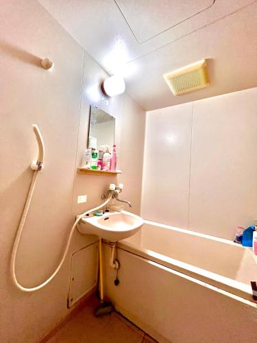 a bathroom with a sink and a bath tub at Shirahama in Miyazaki