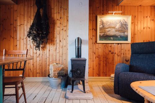 a living room with a wood stove in a room at Sakrisøy Rorbuer in Reine
