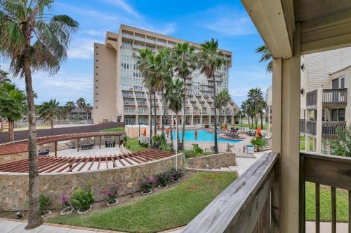 a view of a resort with a pool and palm trees at Easy living, down by the sea! Close to the beach & pool in beautiful beachfront resort in South Padre Island