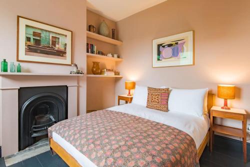 a bedroom with a bed and a fireplace at The Green House in Kent