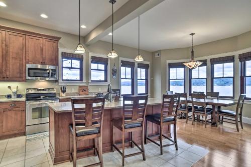 a kitchen with wooden cabinets and a table with chairs at Charming Home on Keuka Lake with Dock and Fire Pit! in Hammondsport