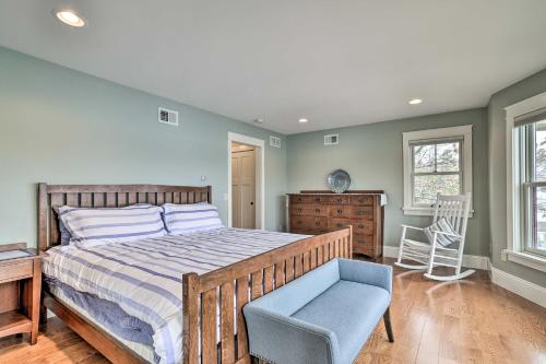 a bedroom with a bed and a blue chair at Charming Home on Keuka Lake with Dock and Fire Pit! in Hammondsport