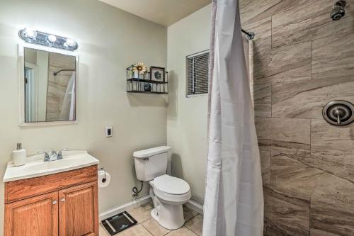 a bathroom with a toilet and a sink and a shower at Kingsburg Home with Patio about 22 Mi to Fresno! in Kingsburg