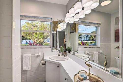 a white bathroom with a sink and a mirror at Reddington Beach Oasis with Pool, Walk to Ocean! in St. Pete Beach