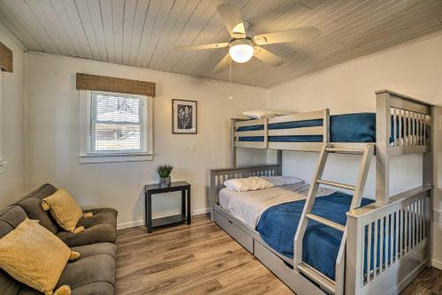 a bedroom with a bunk bed and a couch at Lakeview Mecosta Cottage with Grill and Fire Pit in Mecosta