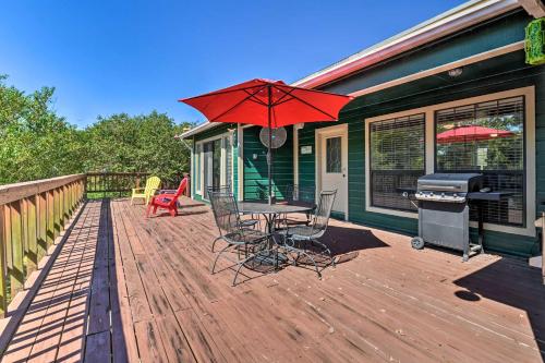 a wooden deck with a table and chairs and a grill at Bay Access and Dock Riverfront Tivoli Escape in Tivoli
