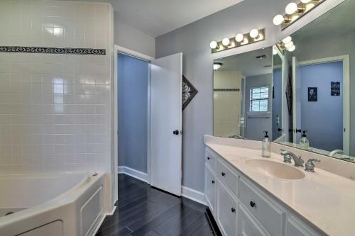 a bathroom with a tub and a sink and a mirror at Bay Access and Dock Riverfront Tivoli Escape in Tivoli