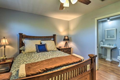 a bedroom with a bed and a bathroom with a sink at Bay Access and Dock Riverfront Tivoli Escape in Tivoli