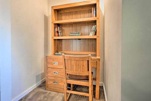 a wooden book shelf with a chair in a room at Hedge House Just 4 miles to Notre Dame! in Granger